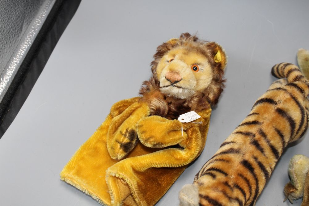 Two 1950s Steiff tigers, a crocodile, a parrot and a lion glove puppet